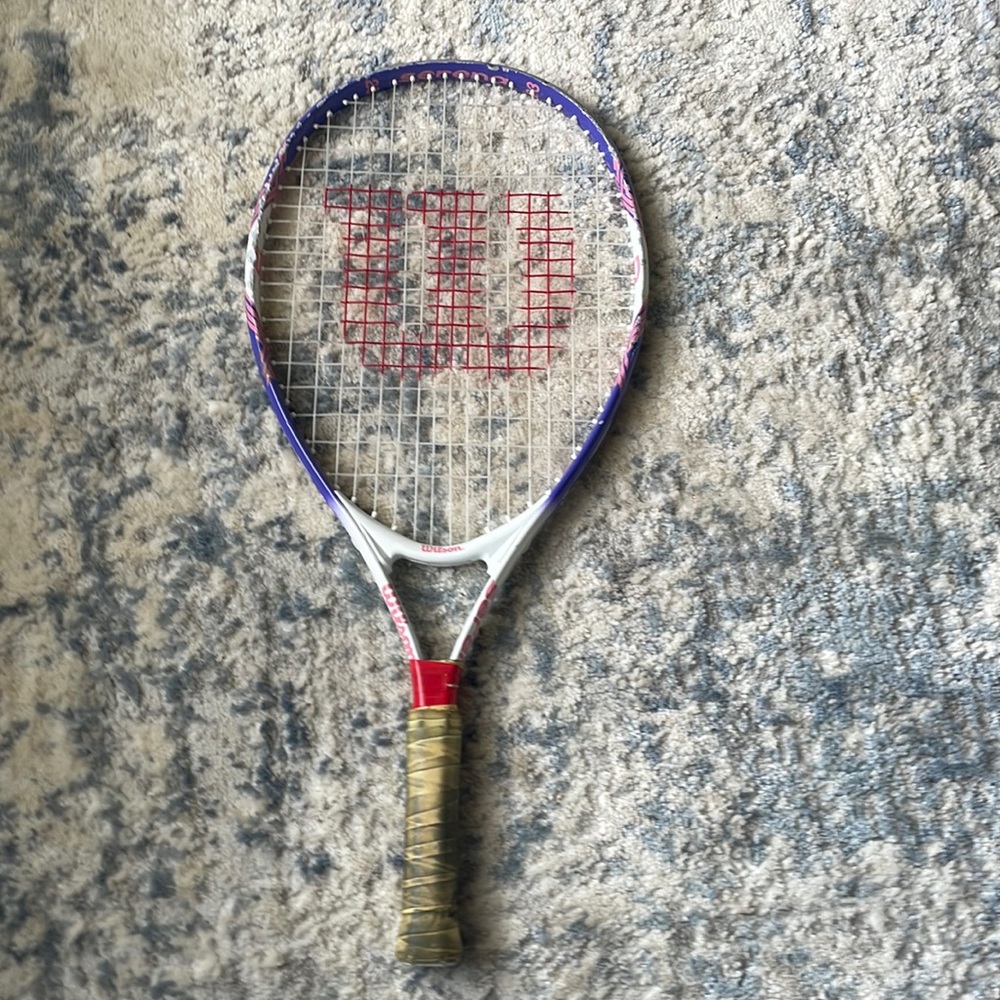 Wilson Purple, pink, and white tennis racket.